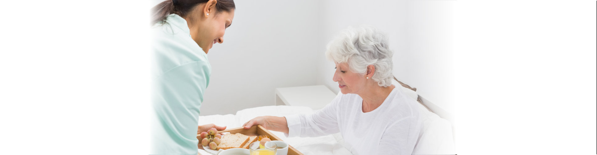 image of a woman giving a food to the elderly woman