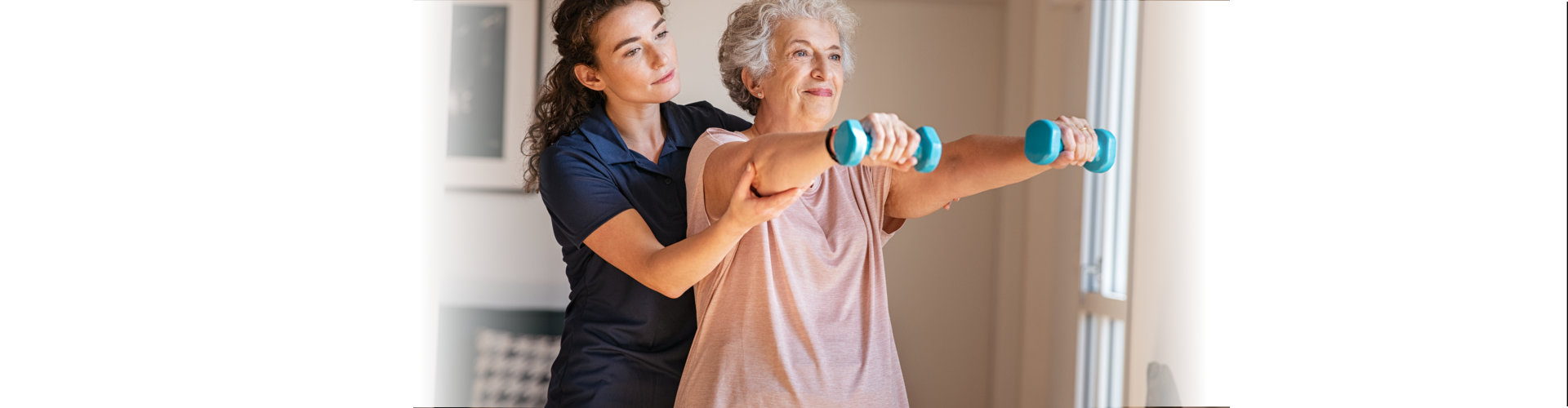 woman caregiving and elderly woman having exercise