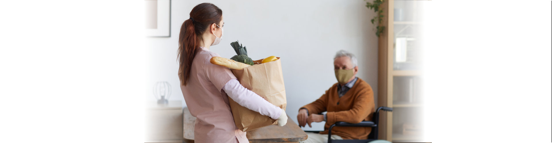 woman caregiver holding a paper bag