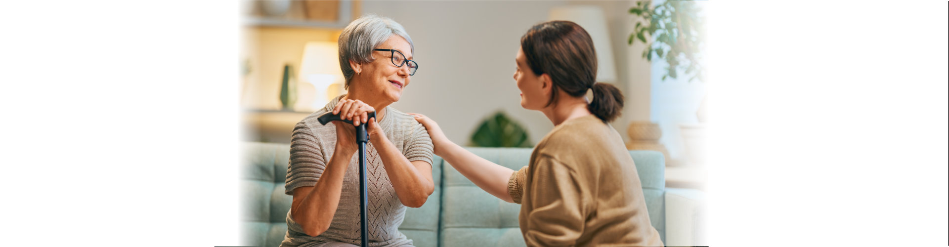 woman caregiver tap the shoulder of the elderly woman