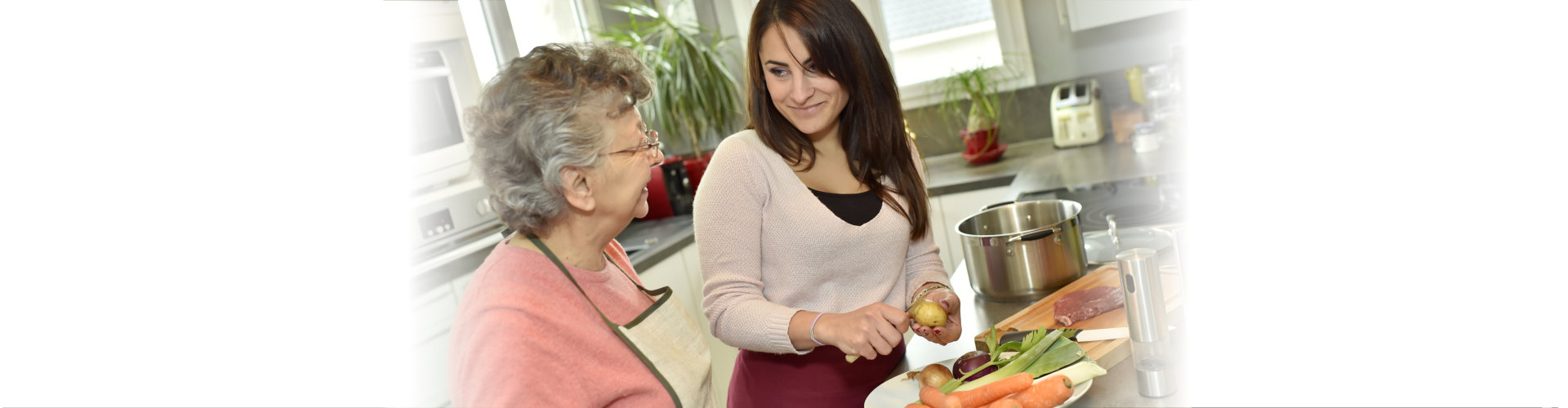 woman help the elderly woman to cook