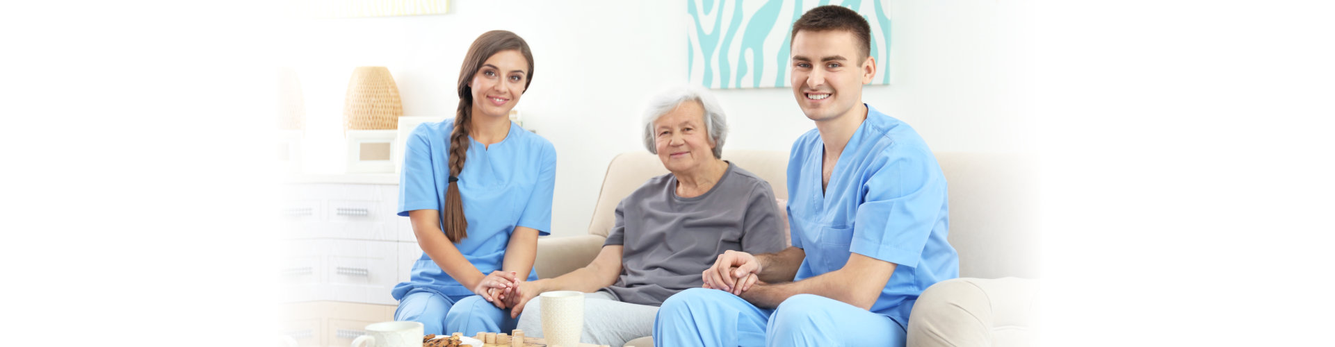 two caregiver holding the hands of elderly and smiling